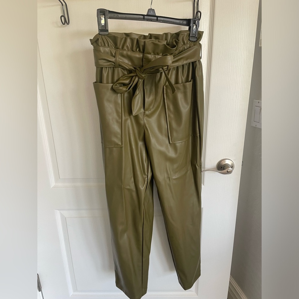 Green faux leather pants with a cinched waist